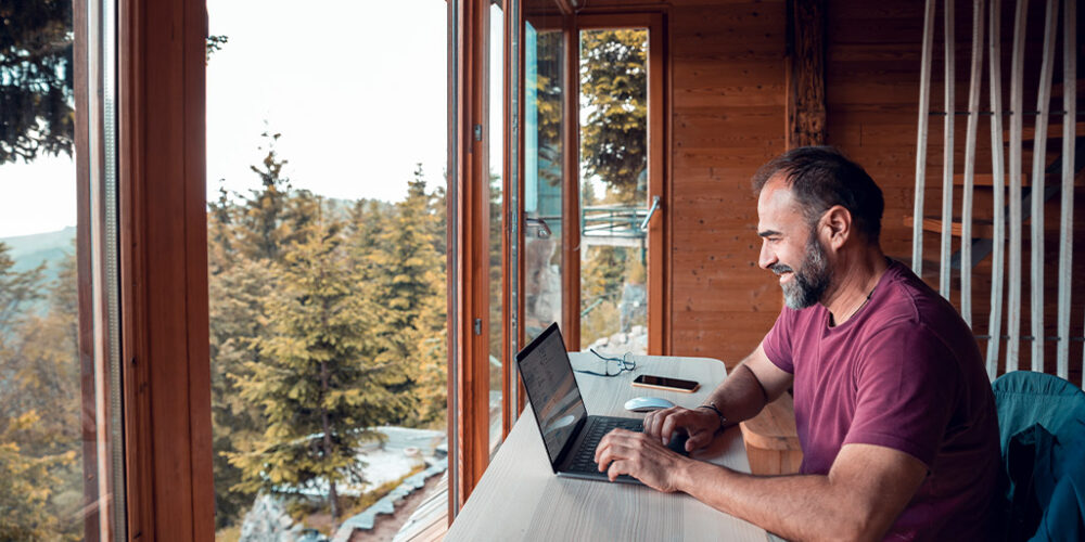 Man working on laptop in cabin