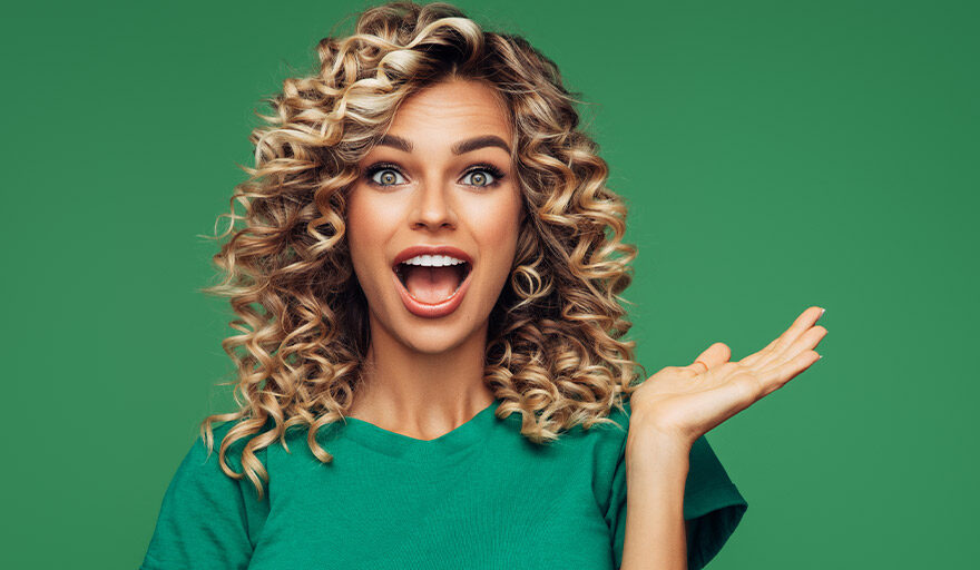 Happy women with curly hair, wearing green