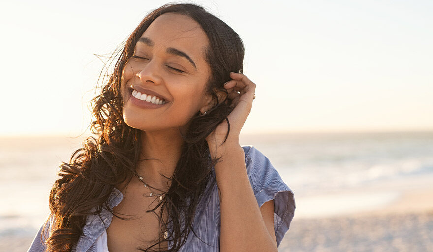 Woman on the beach smiling
