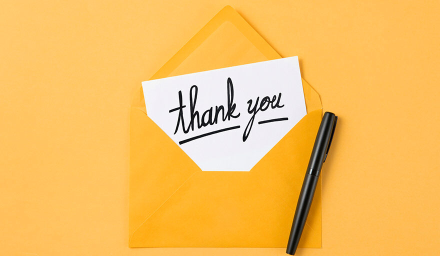 Picture of an envelope with "Thank You" written on the piece of paper sticking out.