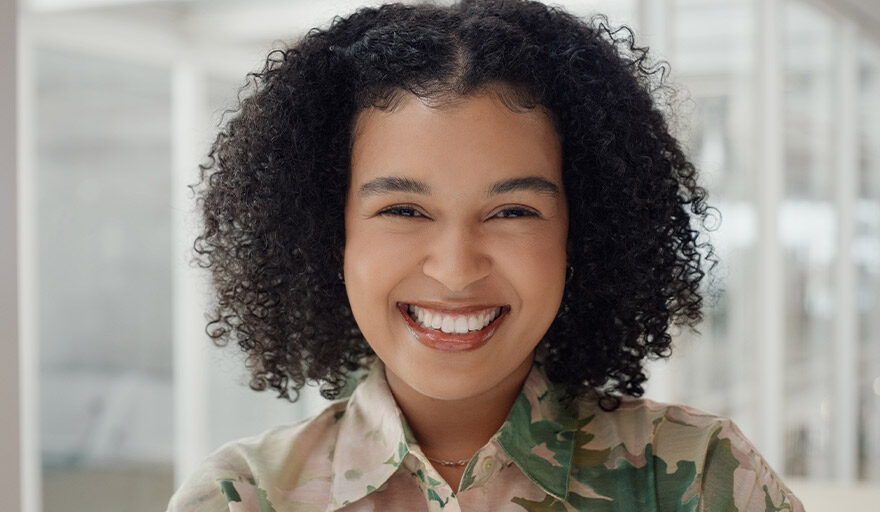 Young woman smiling in a professional headshot