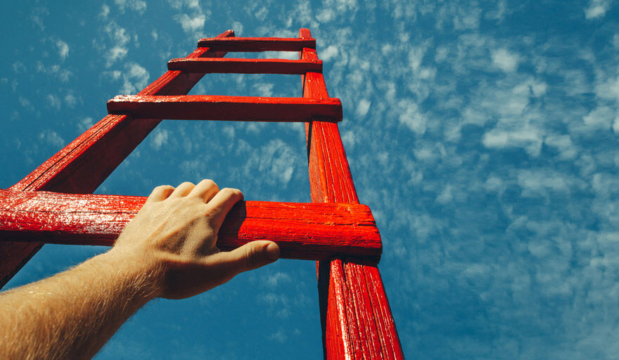 Red ladder in the sky with a man's arm holding a rung.