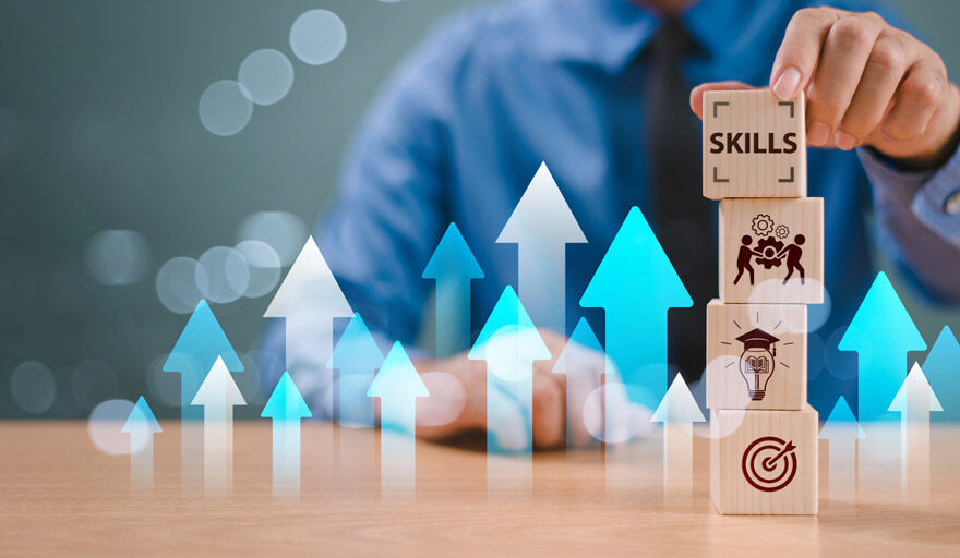 Image of a businessman stacking blocks that highlight skills for advancing one's career